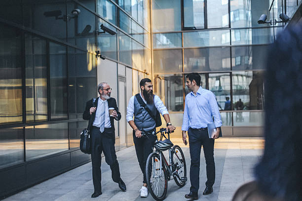 istock Business Professionals Walking with Bicycle Outside Office Building 2252645150