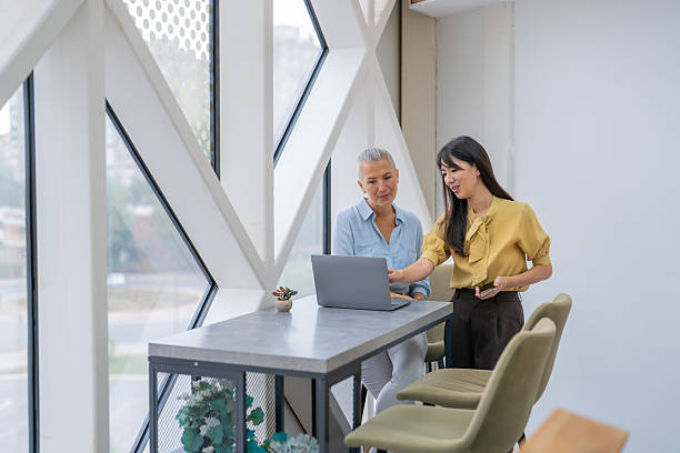istock Businesswomen collaborating on laptop in modern office 2252645218