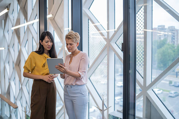 istock Businesswomen using digital tablet in modern office building 2252645220