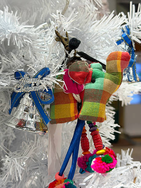 Stock photo shows an unique artificial Christmas tree featuring white needles adorned with silver bell decorations and an Indian elephant ornament. The creative blend of festive elements and cultural symbolism creates a distinctive holiday atmosphere