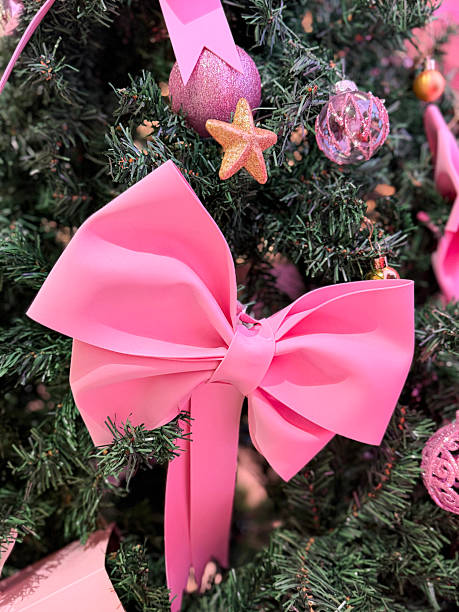 istock Image of artificial christmas tree with pink bows, ribbons, and festive decorations, creating charming holiday ambiance 2252647071