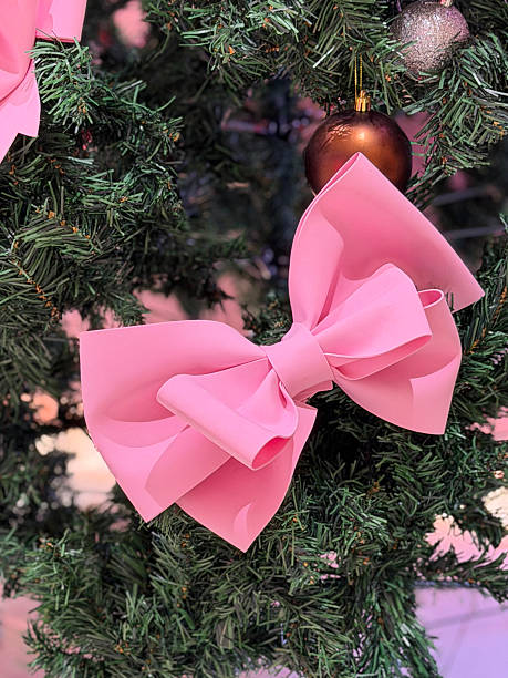 istock Image of artificial christmas tree with pink bows, ribbons, and festive decorations, showcasing cheerful themed holiday decor 2252647077