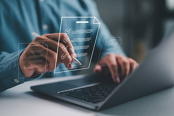 istock Hands completing a digital checklist on a laptop, representing compliance, task management, and the importance of accuracy in business processes. 2252647130