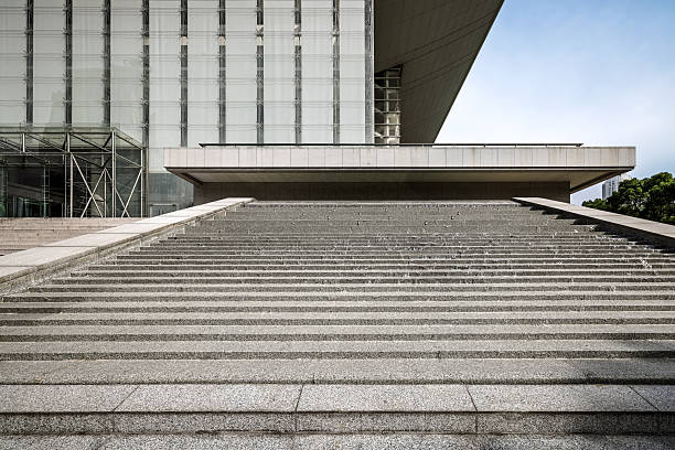 istock Wide stone staircase leading to a modern glass building. 2252648481
