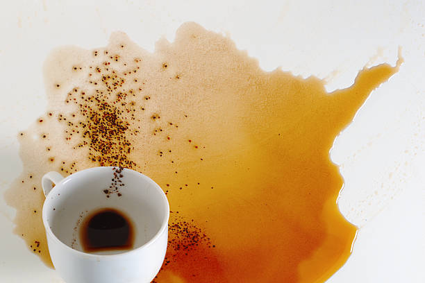 Cup of coffee spilled on table. Conceptual photo