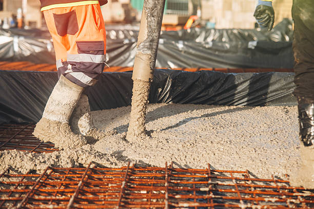 istock Concreters pouring concrete on construction site with safety gear and equipment present 2252654789
