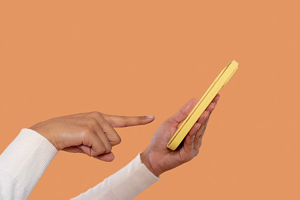istock Person interacting with phone while pointing, showcasing digital connectivity in contemporary setting 2252655545