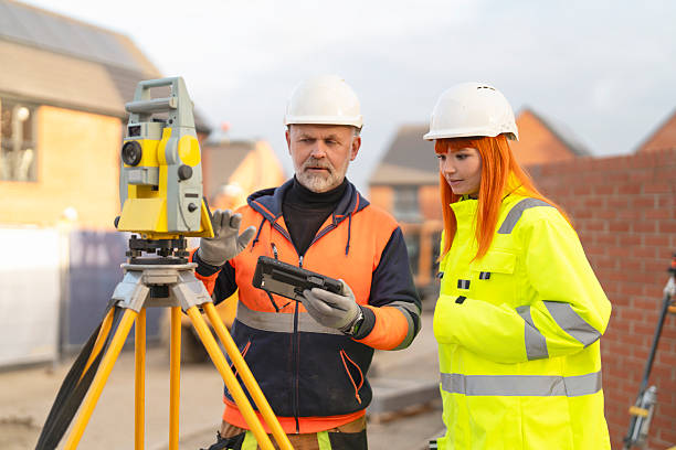 istock Construction surveyors professionals collaborating on site survey using equipment and technology amidst building developments 2252657243
