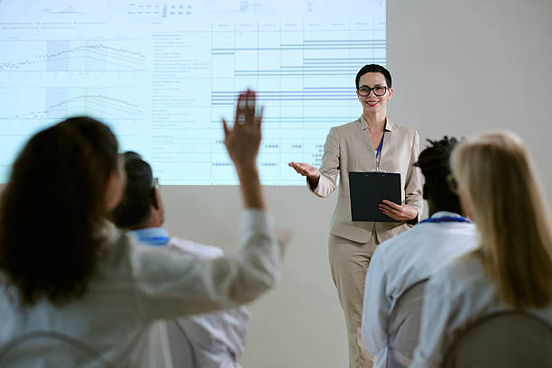 istock Middle Aged Woman Presenting Data to Diverse Group of Professionals 2252659818