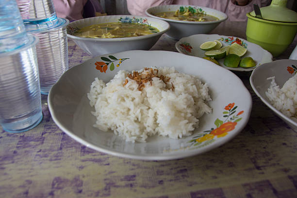 Nasi kuning or yellow rice in thermos.Yellow rice is a typical Indonesian food made from rice cooked with turmeric, coconut milk and spices.Yellow rice is served in Indonesian cultural celebrations.