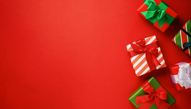 istock Many Christmas gift box lying on festive red background with copy space for text, Christmas card design 2252661880
