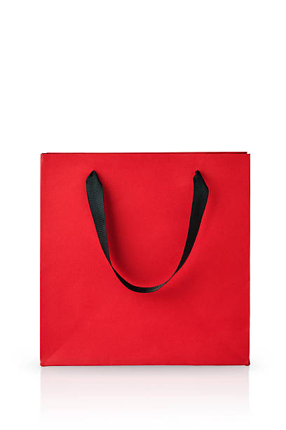 istock One red paper gift bag with black handles isolated on white background with clipping path. Design element. Holiday Sale Concept. 2252661979