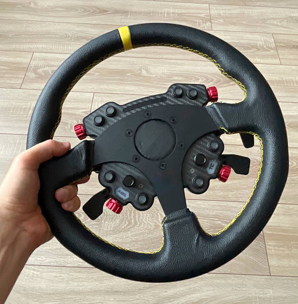 istock A hand grips a steering wheel with detailed controls, highlighting its design and features 2252662898
