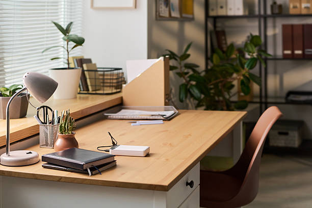 istock Modern Office Desk Featuring Organizer and Potted Plants near Window 2252663819