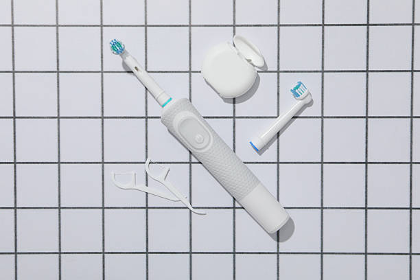 istock Electric toothbrushes and dental floss on light background, top 2252666797