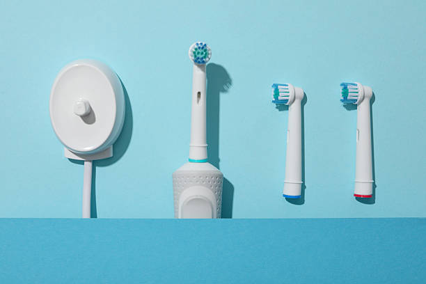 istock Electric toothbrushes and paper on blue background, top view 2252668140