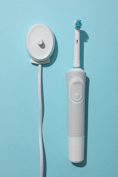 istock Electric toothbrush on blue background, top view 2252668185
