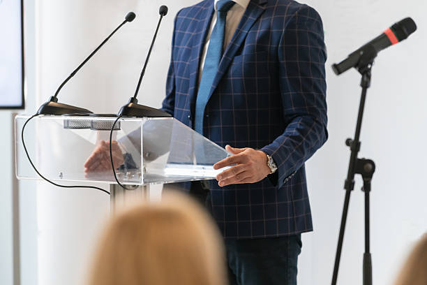 istock Male spokesperson giving official press statement on stage. Captures controlled communication, media focus, and formal public announcement. 2252668563
