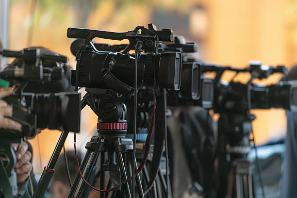 istock Multiple TV cameras positioned in a row capturing press event. Emphasizes organized media presence and professional audiovisual recording. 2252669183