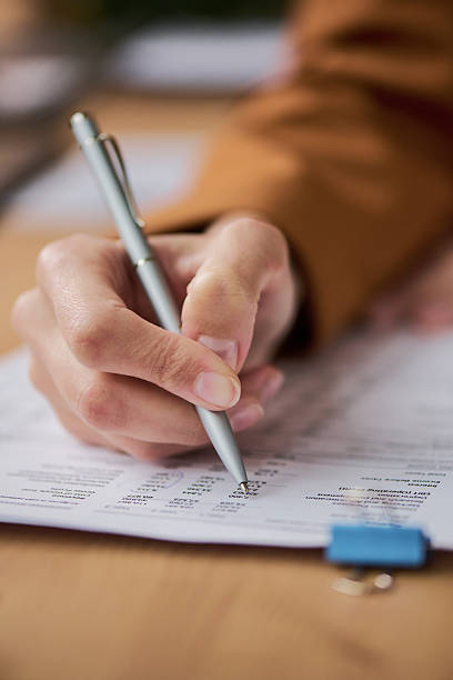istock Female Hand Filling out Form with Pen during Application Process 2252669975