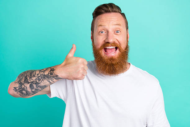 istock Portrait of attractive cheerful cool crazy guy showing thumbup ad solution isolated over bright teal turquoise color background 2252670361