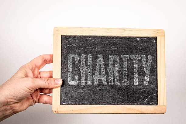 istock CHARITY Concept Displayed On Chalkboard Held By Human Hand 2252671878