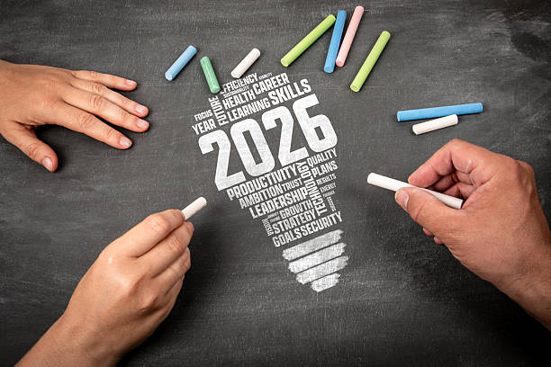 2026 Goals Productivity Growth Concept on a Chalk Texture Blackboard Background and Human Hands