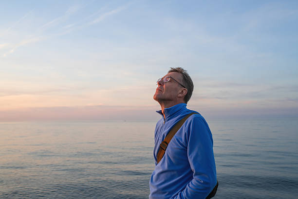 istock Senior man enjoying sunset on the beach 2252674266