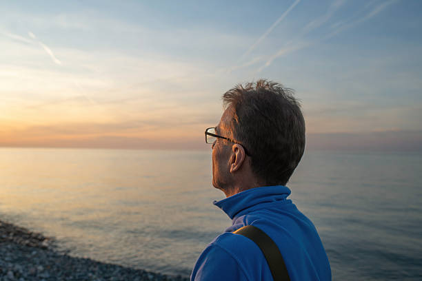 Silhouette of adult man looking at sea during sunset. Almeria, Spain