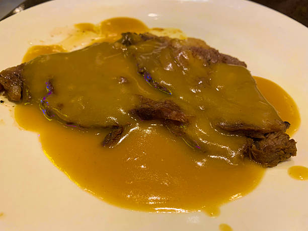 istock Roast Beef with gravy on a white plate 2252674284
