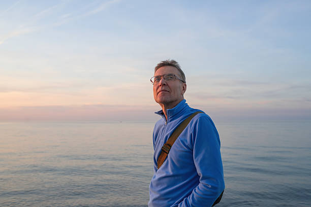 istock Senior man enjoying sunset on the beach 2252674286