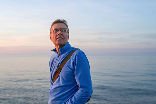 istock Senior man enjoying sunset on the beach 2252674295