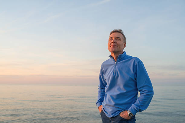 Senior man enjoying sunset on the beach
