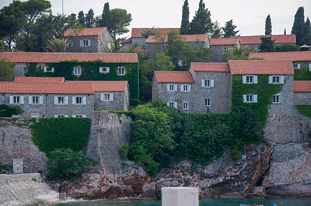 istock Coastal stone houses with red tile roofs and greenery 2252675223