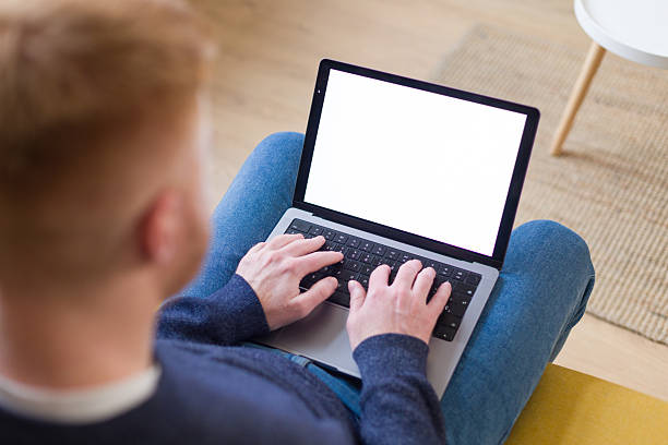 istock Man typing on laptop with mockup screen working from home 2252675650