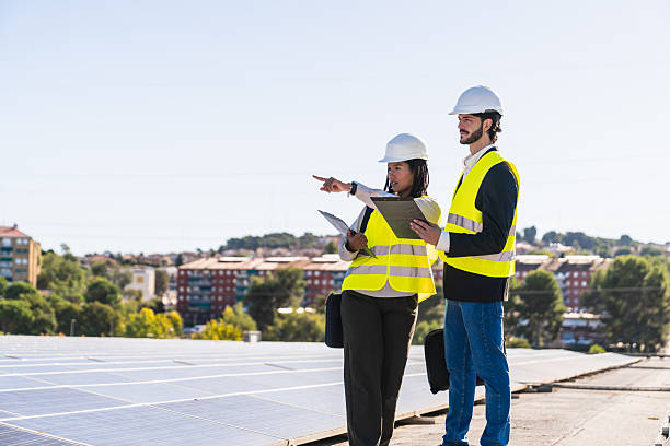istock Engineers inspecting solar panels on rooftop for sustainable energy 2252677053