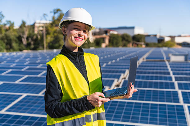 istock Woman engineer managing solar panel installation with laptop 2252677750