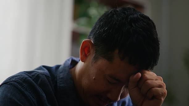 istock Asian Man Feeling Overwhelmed with Worry and Mental Pressure. 2252677801