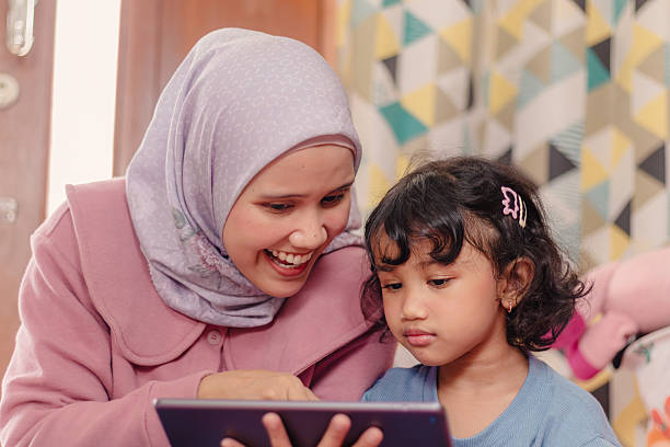 istock An Asian Muslim woman with a happy expression studying with her daughter using a tablet 2252678668