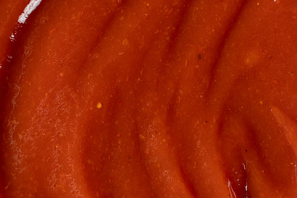 istock Red Ketchup Surface Close-Up. Ingredient Background for Design. 2252680226