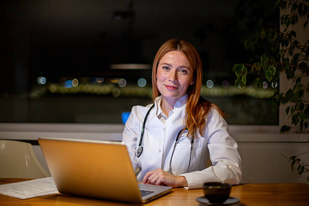 istock Female doctor working night shift using laptop for telemedicine 2252680558