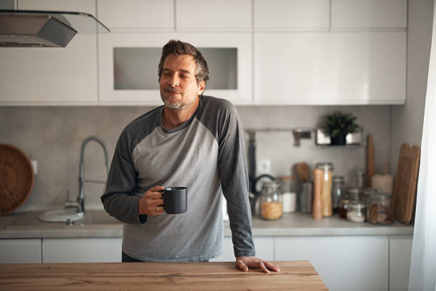 istock Relaxed Man With Coffee Mug In Modern Kitchen Enjoying A Quiet Morning Moment 2252680601