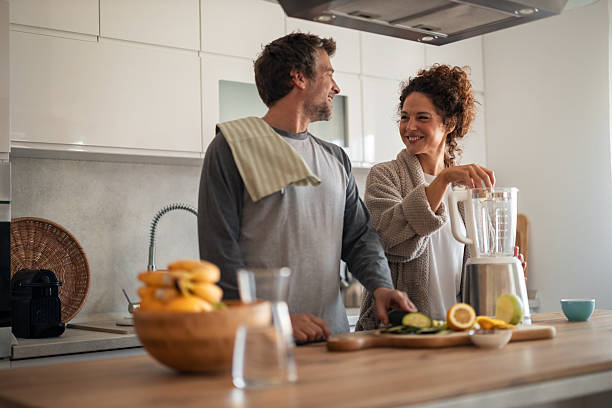 istock Couple Preparing Smoothie in Modern Kitchen, Smiling and Chatting Together 2252680639
