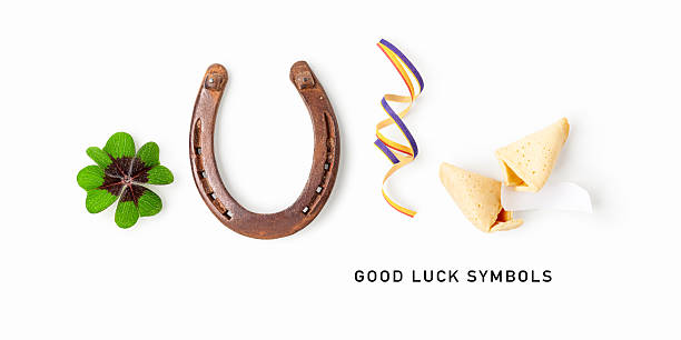 istock Good luck symbols isolated on white background. Composition with four leaf clover, horseshoe, party ribbon and fortune cookie 2252681584