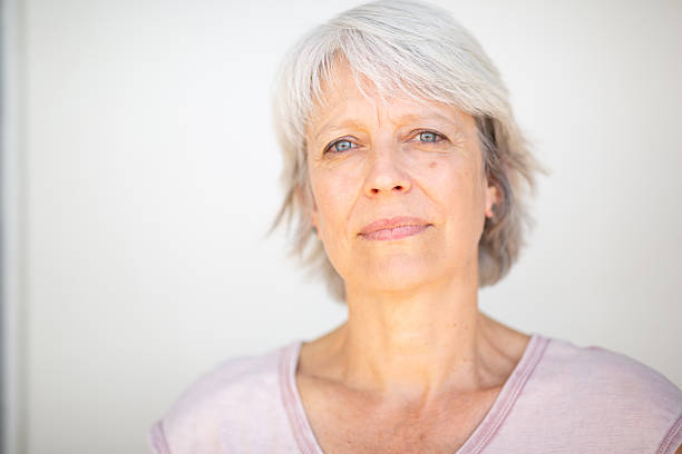 istock Serene older woman with grey hair in thoughtful expression 2252684691