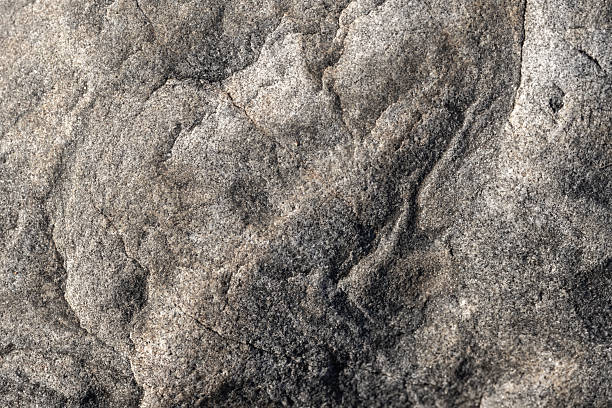 istock A detailed close-up image of a rugged rock surface featuring gray granite tones 2252685217