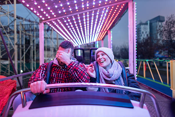istock Couple having fun on an amusement park ride 2252687904