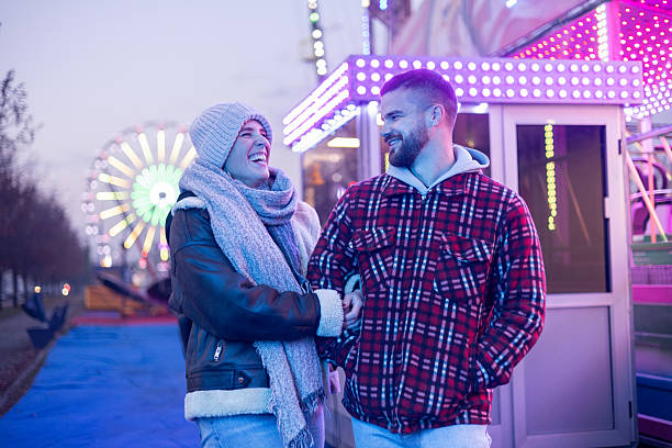 istock Happy couple enjoying winter evening at amusement park 2252687913