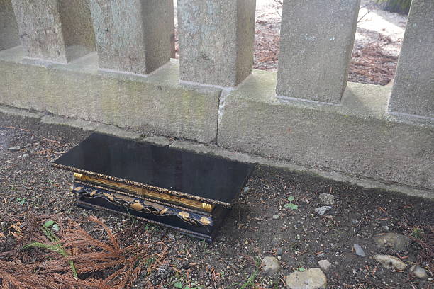 istock A black box is sitting on the ground next to a fence 2252688665