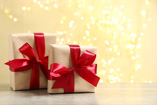 istock Beautiful gift boxes on the table with shining bokeh behind. Ideal for various holidays, birthday or Christmas 2252689327